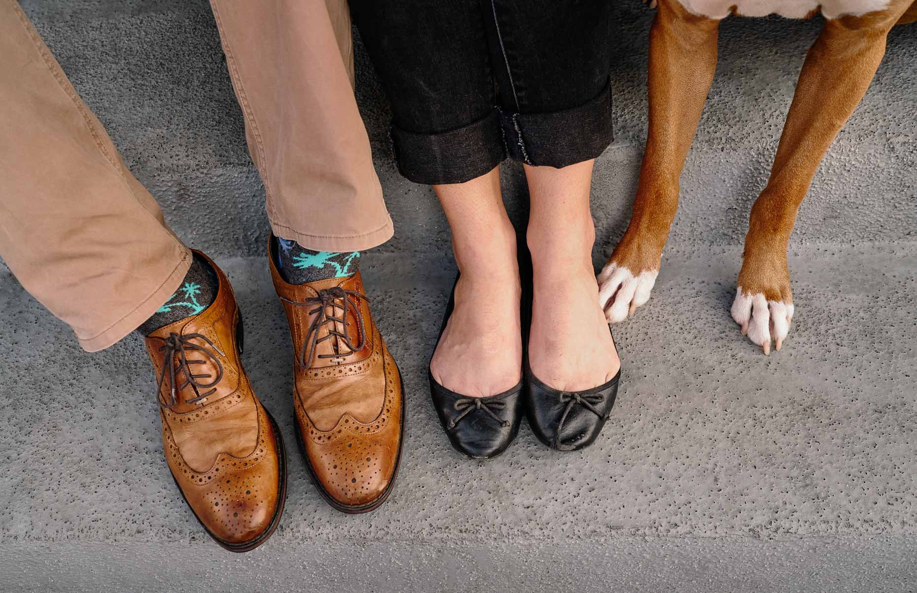 The-feet-of-a-couple-and-their-dog