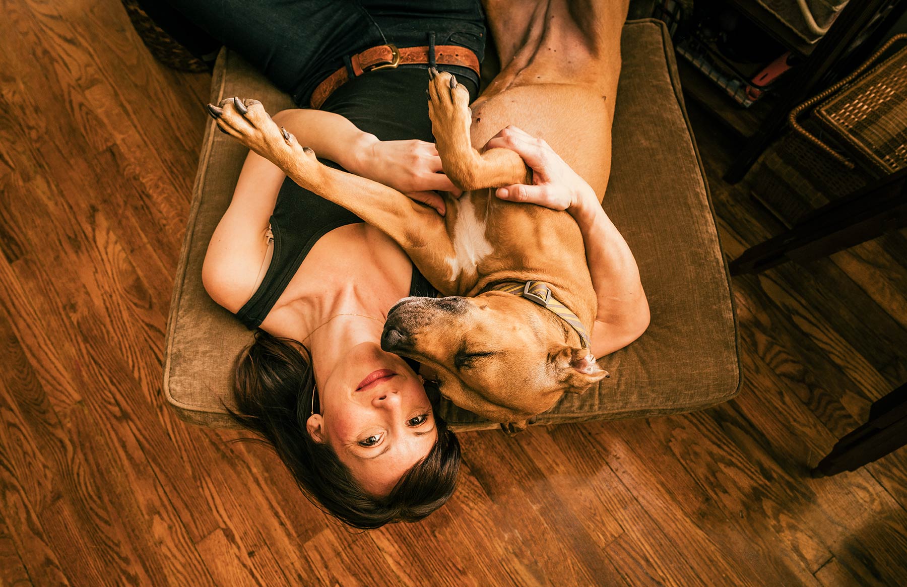 A-woman-and-her-dog-relaxing-on-a-pillow-on-the-floor
