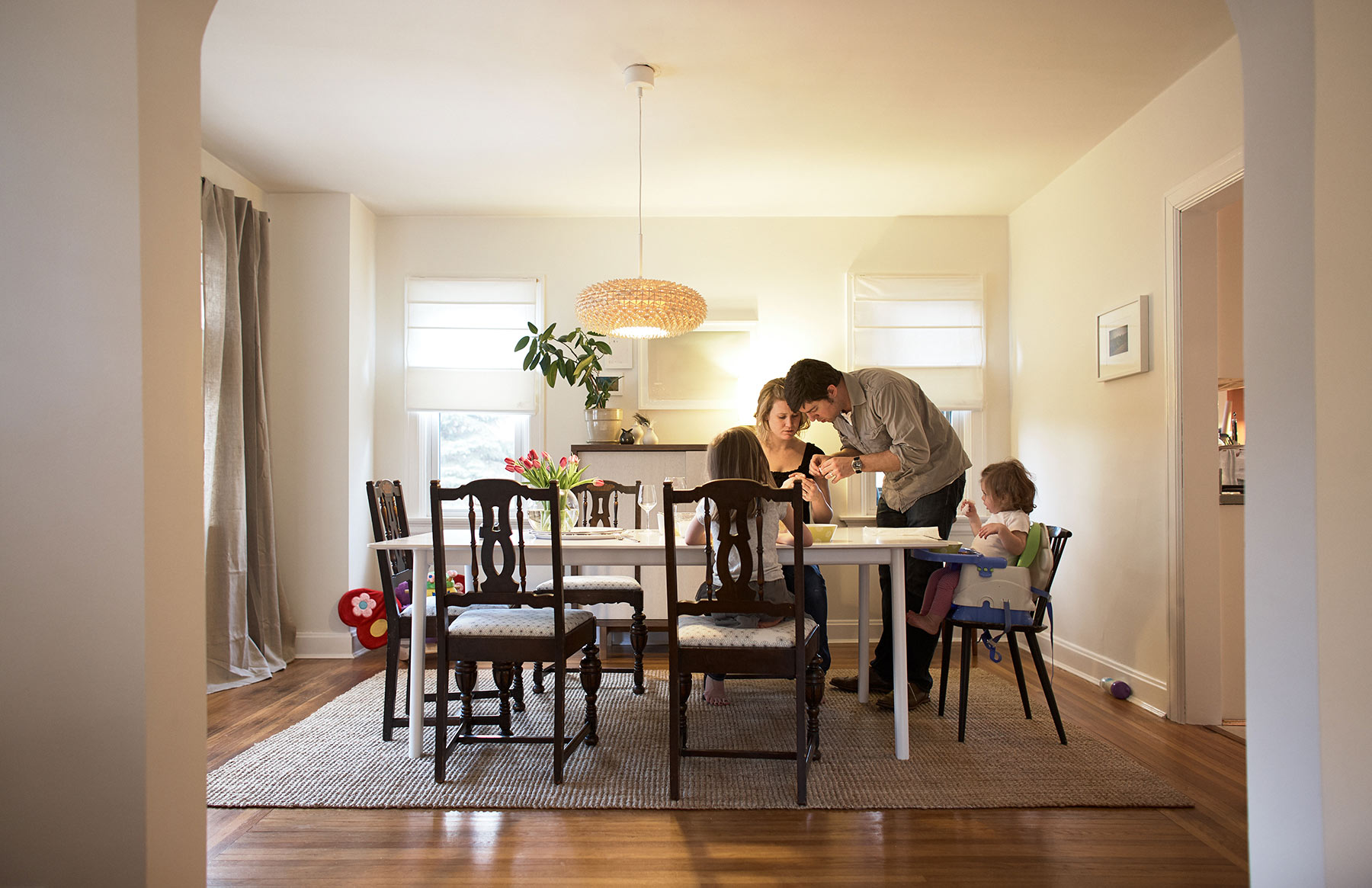 A-family-of-four-gathered-around-their-dining-room-table