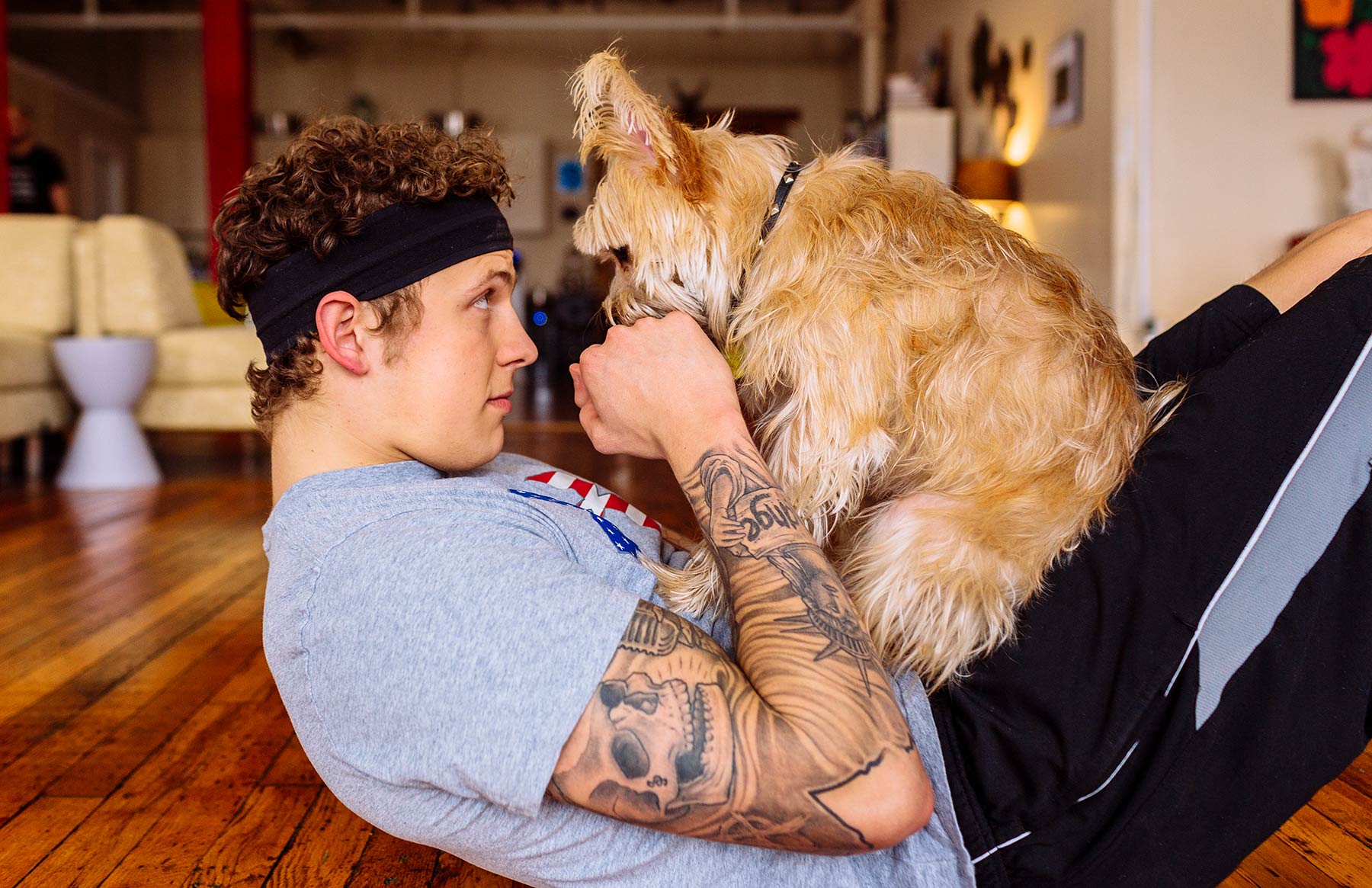 A-young-man-playing-with-a-dog-on-the-floor